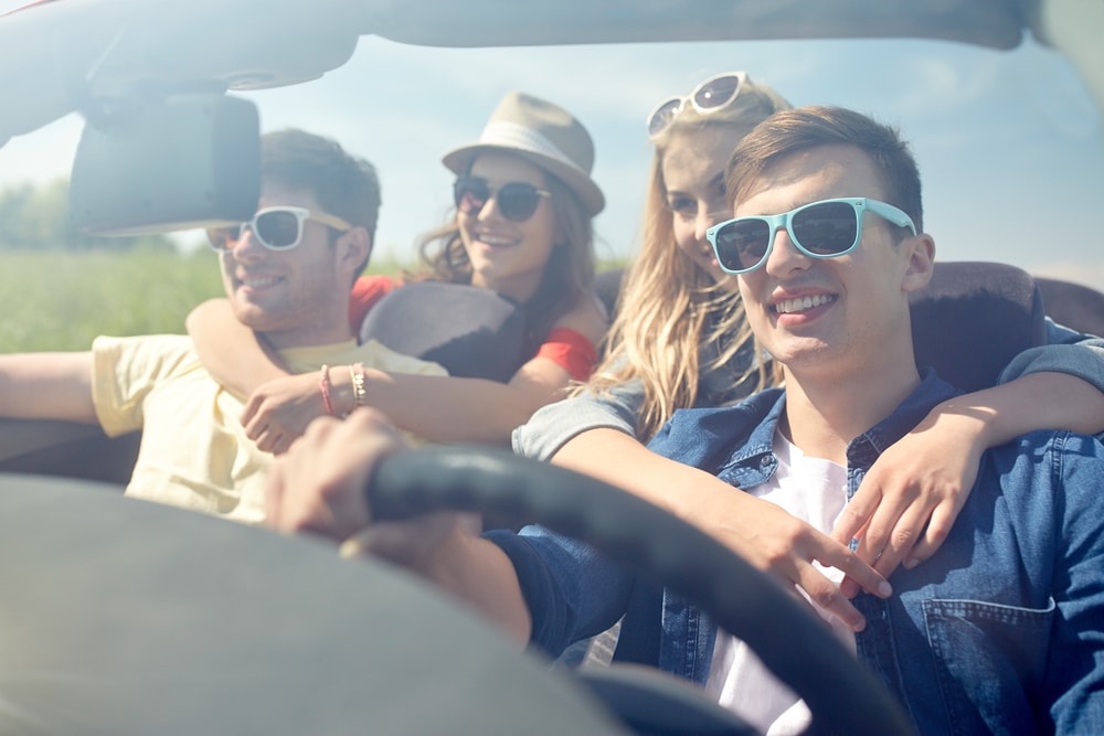 Road trip preparation in Killeen, TX by First Choice Automotive Repair. Image of a group of young friends smiling and enjoying a road trip in a convertible, highlighting the importance of vehicle readiness for a safe and enjoyable journey.