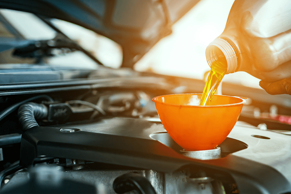 car maintenance tasks, auto repair in Killeen, TX at First Choice Automotive Repair. Image of motor oil being poured into an engine through a funnel.