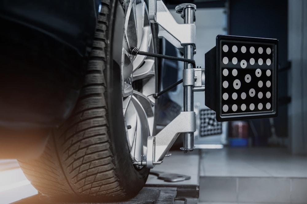 Pre-Holiday Wheel Alignment in Killeen, TX At First Choice Automotive Repair. Close-up view of wheel alignment adjustment on a vehicle at an auto repair shop